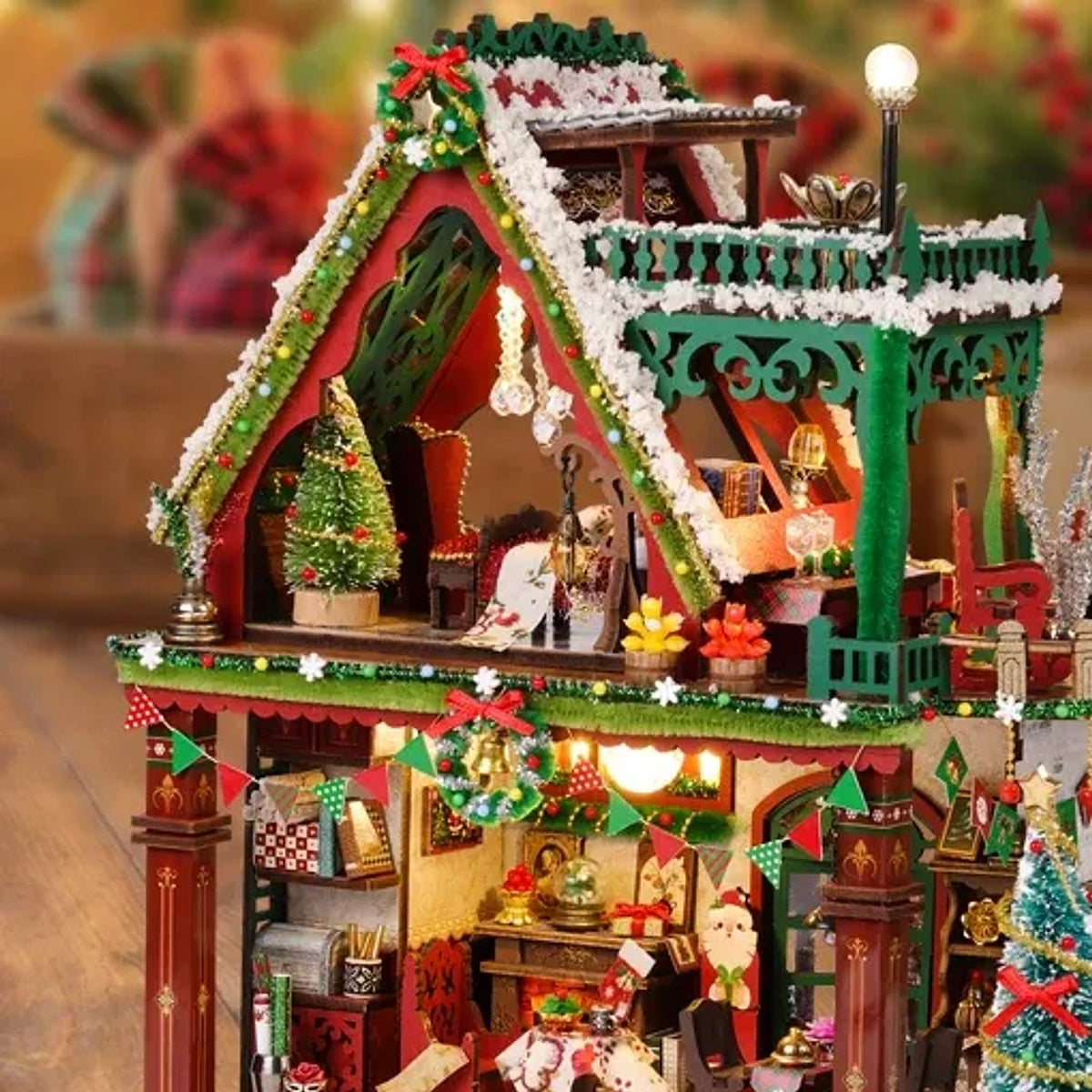 Detail of the lodge upper floor with green railings a small fir tree and hanging ornaments