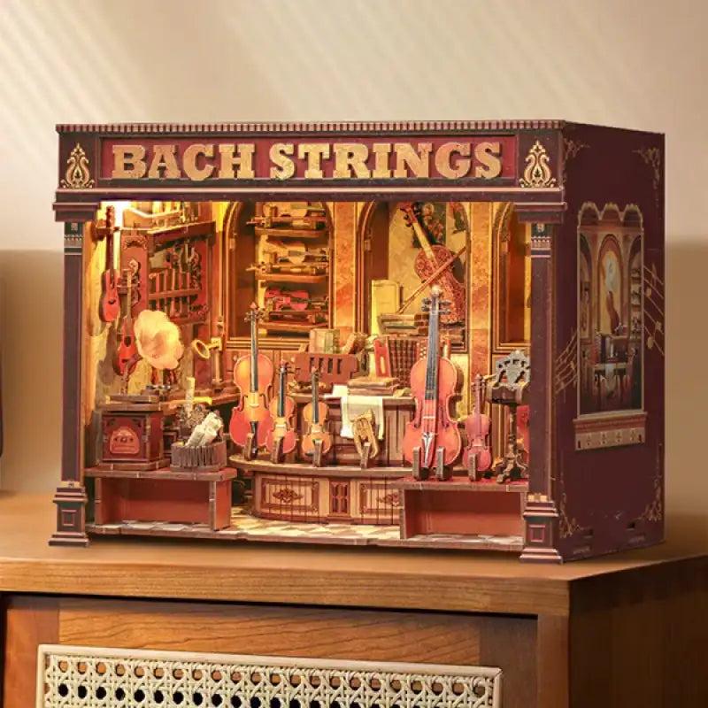 Bach Strings DIY book nook kit lit on a wooden desk