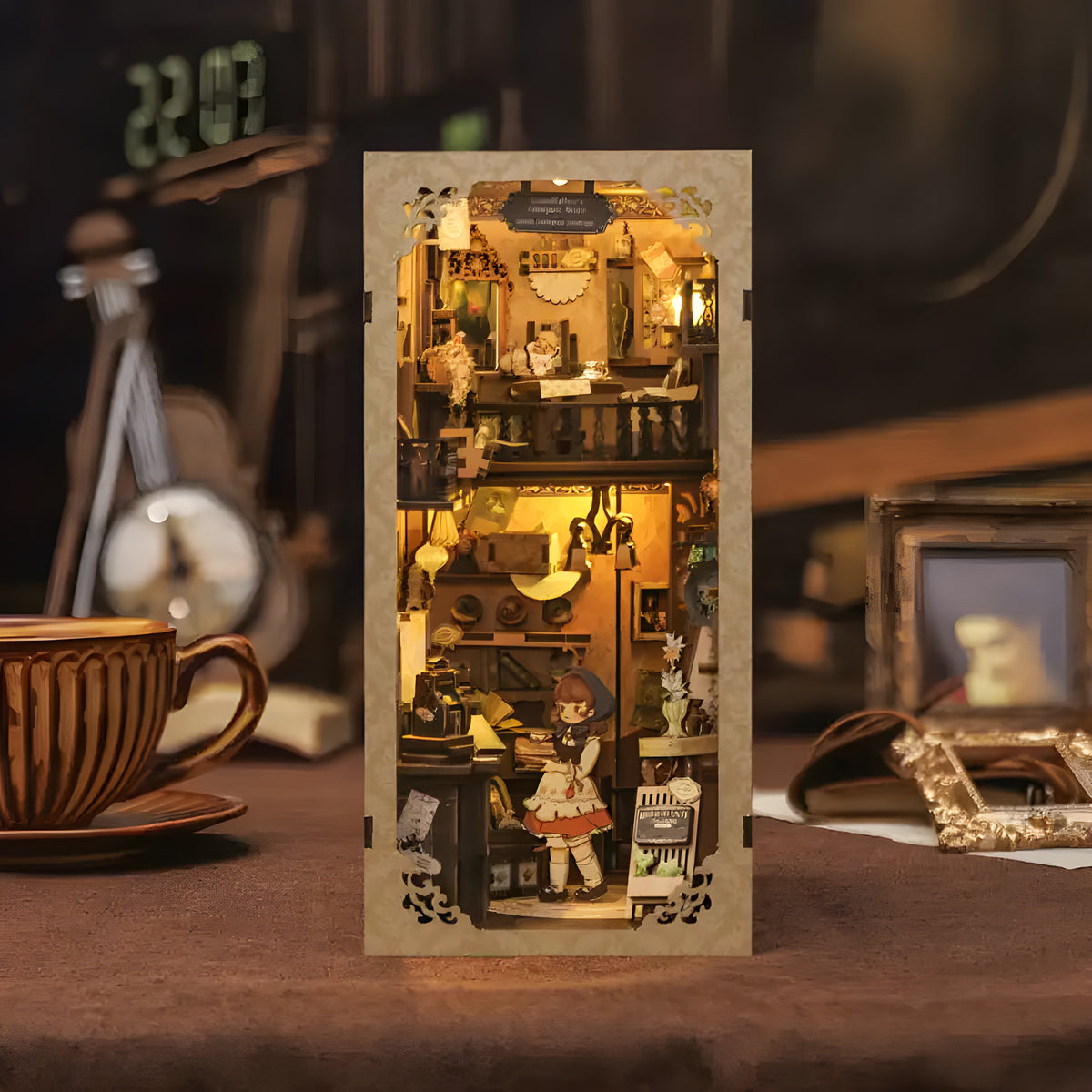 Grandfather's Antique Store DIY book nook kit. Miniature wooden antique shop diorama with vintage clocks, treasures, books, and warm LED lighting. Designed to slide between books on a bookshelf.
