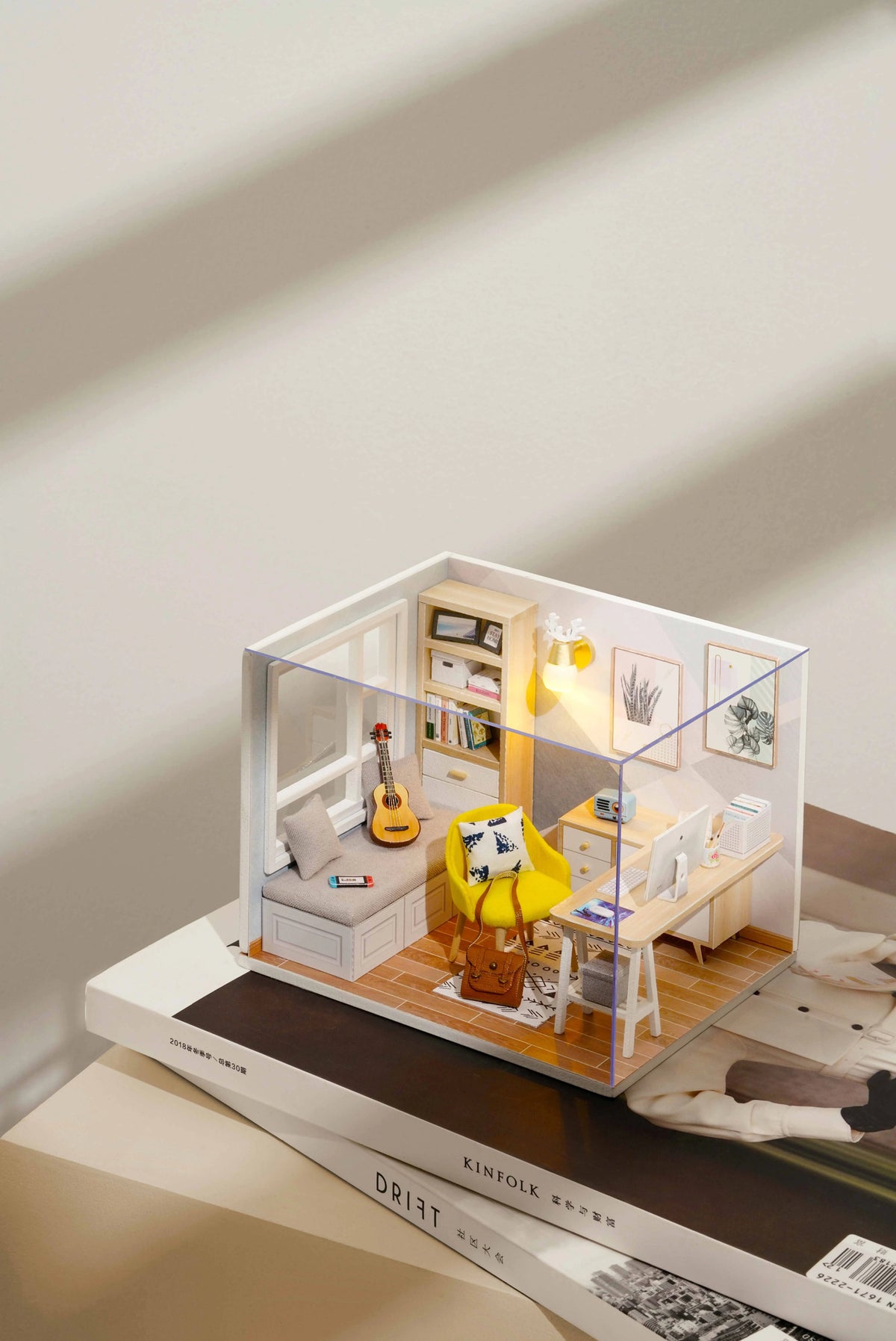 Sunshine Study miniature room kit in its clear dust cover, on a coffee table book