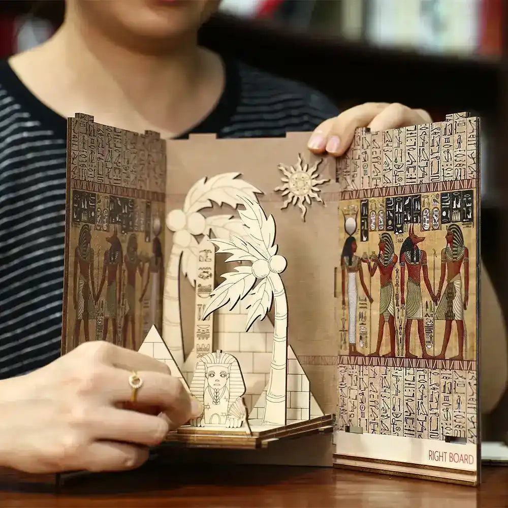 Handcrafted paper art book featuring Egyptian hieroglyphics and a layered pop-up design.