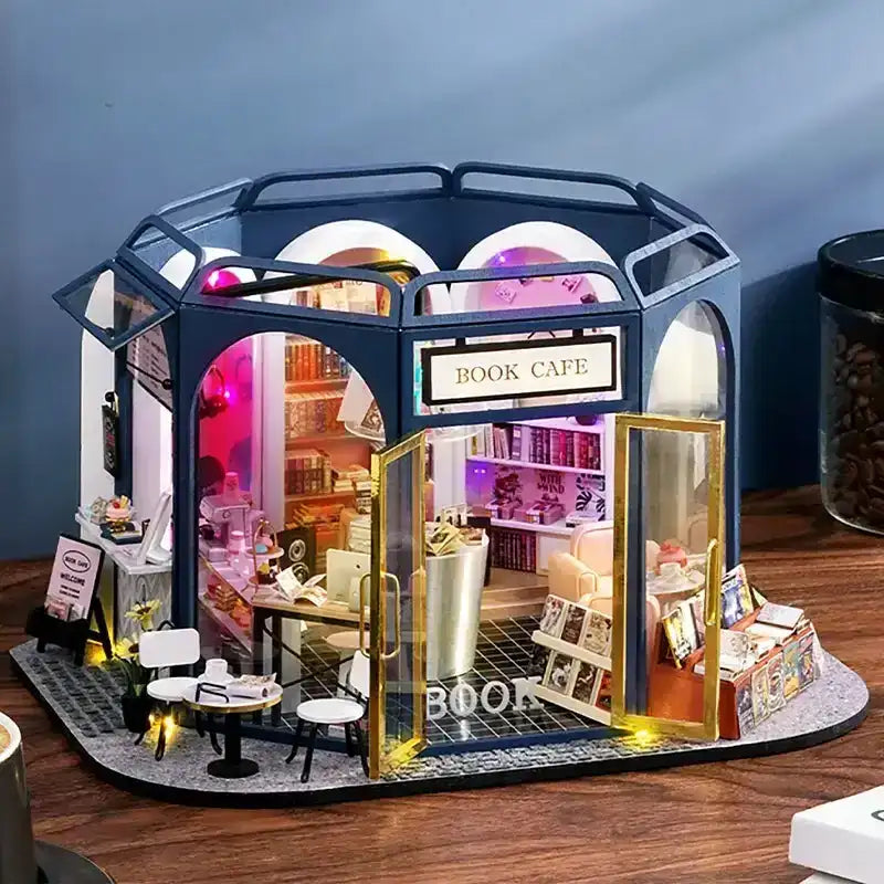 Literary Cafe DIY miniature house kit. Wooden model of a cozy cafe combined with bookshop, full of books, vintage seating, warm coffee details, and LED lighting.