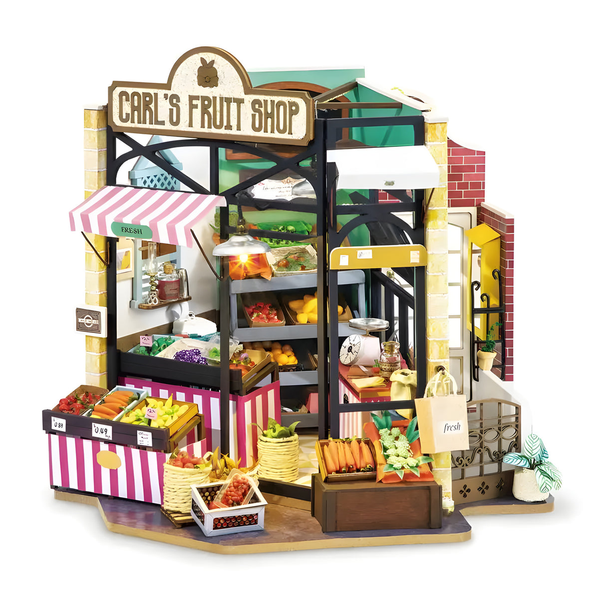 Carl's Fruit Shop DIY miniature house kit. Wooden model of a colorful fruit market with crates of produce, awning, vintage signage, and warm LED lighting.