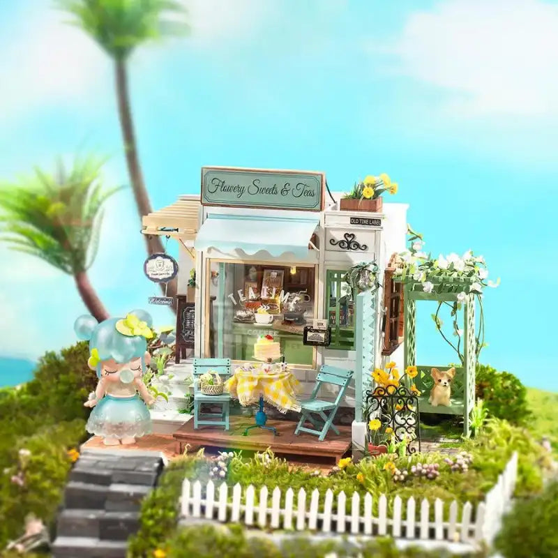 Flowery Sweets and Tea DIY miniature house kit. Wooden model of a charming tea shop interior with floral decor, pastries display, vintage furniture, and warm LED lighting.