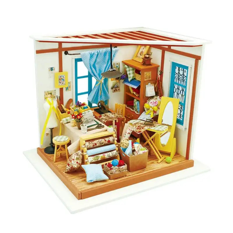 Lisa's Tailor Room DIY miniature house kit. Wooden model of a vintage tailor's workshop with sewing machine, fabrics, mannequin, and warm LED lighting.