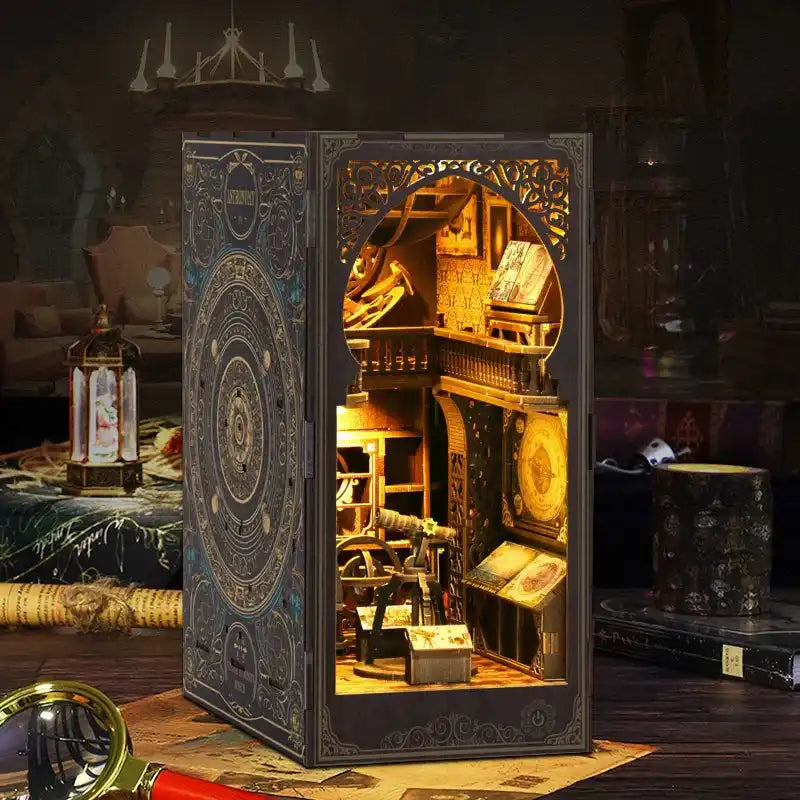 Ornate book-shaped diorama displaying a warmly lit miniature library scene inside.