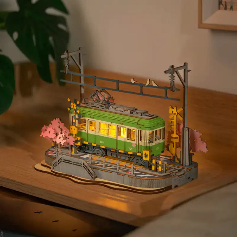 Sakura Journey 3D wooden puzzle. Wooden model of a Japanese train passing through cherry blossom landscape with intricate details. A beautiful collectible DIY build.