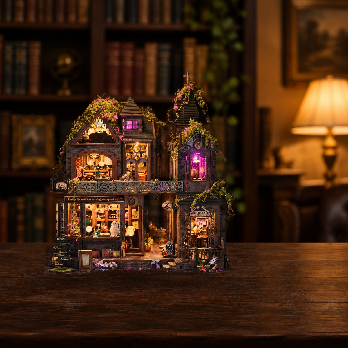 Witch's Lair miniature kit lit on a dark walnut table in a study