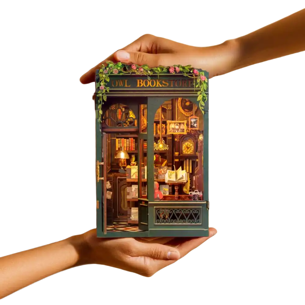 Assembled Book Nook kit displayed between books on a shelf